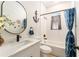 Bright bathroom features a shower-tub combination with nautical-themed decor at 46 Fisher Lane Ter, Ocklawaha, FL 32179