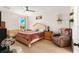 Bright bedroom featuring a cozy armchair, a crib, and a comfortable queen size bed at 46 Fisher Lane Ter, Ocklawaha, FL 32179