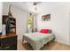 Quaint bedroom with a simple bed, ample natural light from the window, and playful dinosaur-themed decorations at 46 Fisher Lane Ter, Ocklawaha, FL 32179