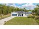 Charming home featuring a well-manicured lawn, attached garage, and a basketball hoop at 46 Fisher Lane Ter, Ocklawaha, FL 32179
