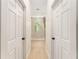 Hallway view leading to a bathroom with a modern tile shower and a window providing natural light at 46 Fisher Lane Ter, Ocklawaha, FL 32179