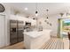 Modern kitchen with stainless steel appliances, quartz countertops, and an open design leading to outdoor views at 46 Fisher Lane Ter, Ocklawaha, FL 32179