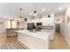 Bright open kitchen featuring a quartz countertop island, stainless steel appliances, and sleek modern cabinetry at 46 Fisher Lane Ter, Ocklawaha, FL 32179
