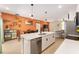 Stylish kitchen boasts a quartz countertop island, stainless steel appliances, and an open view to the dining and living areas at 46 Fisher Lane Ter, Ocklawaha, FL 32179