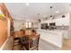 Open-concept kitchen with stainless steel appliances, white cabinets, and a view to the adjacent dining and living areas at 46 Fisher Lane Ter, Ocklawaha, FL 32179