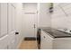 A laundry room features a modern washer and dryer, plus shelving at 46 Fisher Lane Ter, Ocklawaha, FL 32179