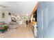 Bright, open-concept living space flows into the kitchen with a fireplace and modern furnishings at 46 Fisher Lane Ter, Ocklawaha, FL 32179
