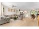 Open-concept living area with modern furnishings, a ceiling fan, and a view of the kitchen and dining area at 46 Fisher Lane Ter, Ocklawaha, FL 32179