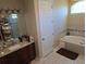Luxurious bathroom featuring a soaking tub, separate vanities, and a spacious walk-in shower for a spa-like experience at 4770 Sw 114Th St, Ocala, FL 34476
