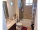 Cozy bathroom featuring a combined tub and shower, a vanity with a sink, and tiled walls at 4770 Sw 114Th St, Ocala, FL 34476