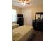 Cozy bedroom with twin beds, dark wood dressers, and natural light from the window at 4770 Sw 114Th St, Ocala, FL 34476