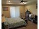 Well-lit bedroom featuring a ceiling fan, a large window, and a comfortable bed at 4770 Sw 114Th St, Ocala, FL 34476
