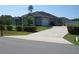 Charming single-story home featuring a well-maintained lawn and a long private driveway leading to an attached garage at 4770 Sw 114Th St, Ocala, FL 34476
