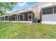 Townhome backyard featuring a grassy area and screened-in patios at 4927 Sw 45Th Cir, Ocala, FL 34474