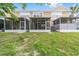 Backyard showcasing the rear exterior and screened-in patios at 4927 Sw 45Th Cir, Ocala, FL 34474