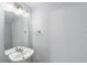Powder room featuring a pedestal sink, neutral paint, and a bright mirror with multi-bulb lighting at 4927 Sw 45Th Cir, Ocala, FL 34474