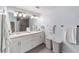 Bathroom featuring a double sink vanity, large mirror, and modern fixtures at 4927 Sw 45Th Cir, Ocala, FL 34474