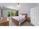 Bright bedroom featuring a large window with natural light and a ceiling fan at 4927 Sw 45Th Cir, Ocala, FL 34474