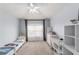 Light-filled bedroom featuring a ceiling fan, carpeted floors, and neutral walls at 4927 Sw 45Th Cir, Ocala, FL 34474