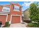 Charming townhome with a well-maintained lawn, driveway, and colorful exterior at 4927 Sw 45Th Cir, Ocala, FL 34474