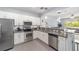 Gourmet kitchen featuring stainless steel appliances, granite counters, and a pass-through window to the living area at 4927 Sw 45Th Cir, Ocala, FL 34474