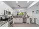 Well-lit kitchen featuring white cabinets, stainless steel appliances and granite countertops at 4927 Sw 45Th Cir, Ocala, FL 34474