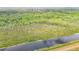 Aerial view captures the serene canal winding through the dense greenery, reflecting the landscape's tranquility at 505 Fisher Rd, Ocklawaha, FL 32179