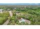 Aerial view of a cozy home surrounded by a forest, offering privacy and nature at 505 Fisher Rd, Ocklawaha, FL 32179