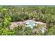 Aerial view of the home with a green metal roof, surrounded by trees at 505 Fisher Rd, Ocklawaha, FL 32179