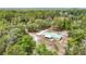 Birds eye view of property featuring a metal roof, screen porch, and wooded acreage at 505 Fisher Rd, Ocklawaha, FL 32179