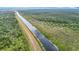 Panoramic aerial view highlights a serene canal surrounded by lush greenery, showcasing the peaceful setting at 505 Fisher Rd, Ocklawaha, FL 32179