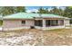 The back of this home features a screened in porch and a fenced backyard at 505 Fisher Rd, Ocklawaha, FL 32179