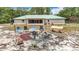 Secluded backyard boasts a fire pit and ample seating, ideal for outdoor gatherings and relaxation at 505 Fisher Rd, Ocklawaha, FL 32179