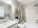 Well-lit bathroom with a shower-tub combination and patterned shower curtain with leaf design at 505 Fisher Rd, Ocklawaha, FL 32179