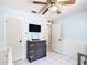 Charming bedroom with a television, tile floors, neutral walls, and plenty of natural light at 505 Fisher Rd, Ocklawaha, FL 32179