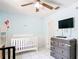 Charming bedroom with a television, tile floors, neutral walls, and plenty of natural light at 505 Fisher Rd, Ocklawaha, FL 32179