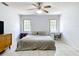 Bedroom featuring tile flooring, desk, natural light from two windows, and a ceiling fan at 505 Fisher Rd, Ocklawaha, FL 32179