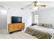 Bedroom featuring tile flooring, window, ceiling fan, dresser and a neatly made bed at 505 Fisher Rd, Ocklawaha, FL 32179