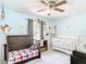 Charming bedroom featuring cartoon decorations and tile floors, designed for comfort and imagination at 505 Fisher Rd, Ocklawaha, FL 32179