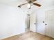 Clean bedroom features laminate floors, neutral walls, ceiling fan and multiple white panel doors at 505 Fisher Rd, Ocklawaha, FL 32179