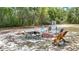 Backyard featuring a fire pit area, perfect for entertaining or enjoying quiet outdoor evenings at 505 Fisher Rd, Ocklawaha, FL 32179