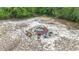 Aerial view of a fire pit area with seating nestled in a private wooded area at 505 Fisher Rd, Ocklawaha, FL 32179