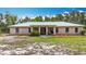 Charming single-story home featuring a light-colored metal roof and a simple, landscaped front yard at 505 Fisher Rd, Ocklawaha, FL 32179