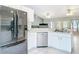 Bright kitchen featuring stainless steel appliances and white cabinetry, with an open layout at 505 Fisher Rd, Ocklawaha, FL 32179