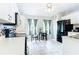 Bright kitchen featuring eat-in breakfast nook, stainless appliances, and tile flooring at 505 Fisher Rd, Ocklawaha, FL 32179