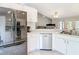 Bright kitchen featuring stainless steel appliances and white cabinetry, with an open layout at 505 Fisher Rd, Ocklawaha, FL 32179