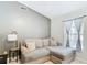 Comfortable living room features neutral paint, tile floors, and a cozy sectional sofa near a bright window at 505 Fisher Rd, Ocklawaha, FL 32179