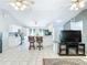 Open concept living room with eat-in kitchen and breakfast bar at 505 Fisher Rd, Ocklawaha, FL 32179