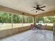 Enjoy views of the spacious backyard from the comfort of the screened in porch at 505 Fisher Rd, Ocklawaha, FL 32179