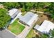 Aerial view of home with green lawn and driveway at 518 Saint Andrews Blvd, Lady Lake, FL 32159